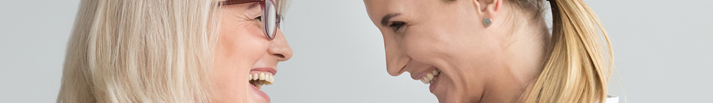 Mother and Daughter Looking at Each Other and Laughing.