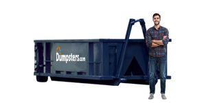 contractor standing in front of construction dumpster