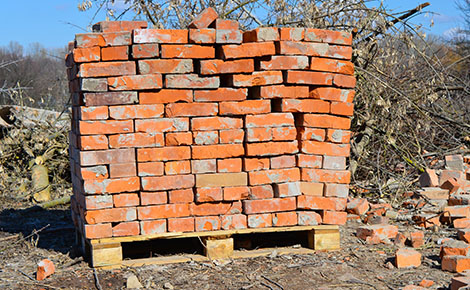 Pile of reclaimed bricks stacks on a pallet.