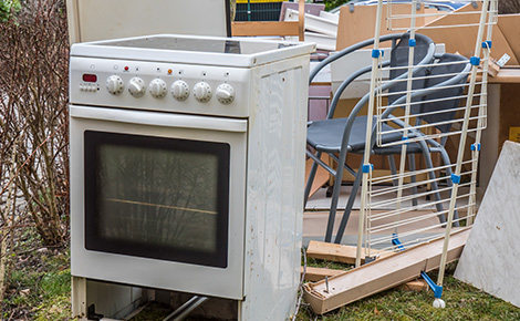 A white oven sitting outside in a yard.