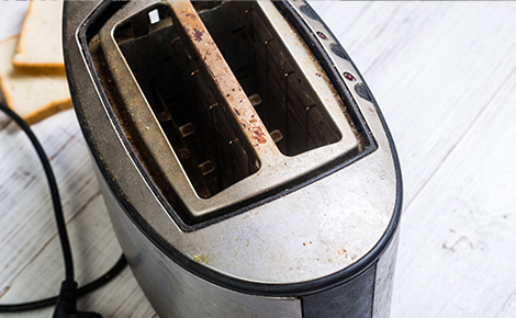 An unplugged stainless steel toaster on a counter.