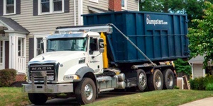 A Blue Dumspters.com Roll Off Dumpster.