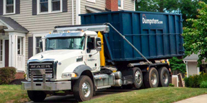 a dumpsters.com roll off dumpster truck in a driveway