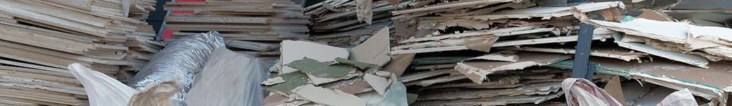 Stacks of drywall and other remodeling debris.