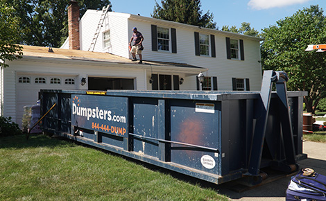 Dumpsters.com dumpster in front of residential construction job.