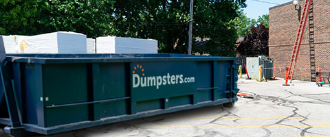 Roofing dumpster on a commerical roofing jobsite.