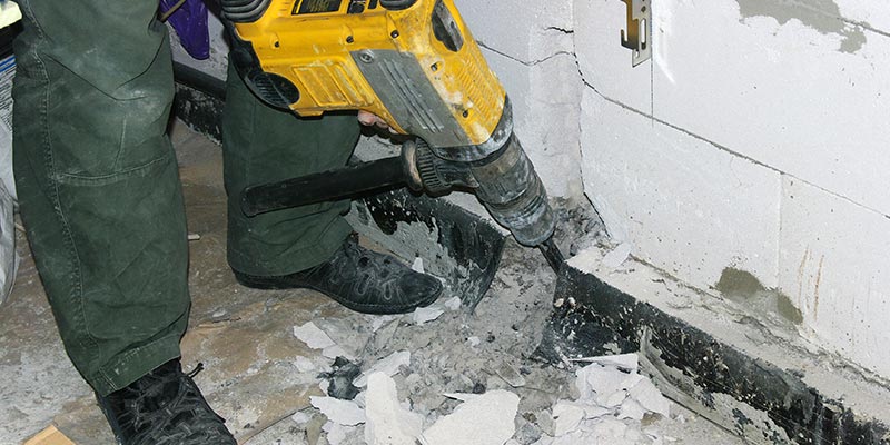 Rotary Hammer Being Used to Break Apart a Wall.