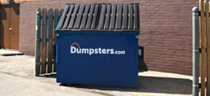 Front Load Bin in Front of a Brick Wall.