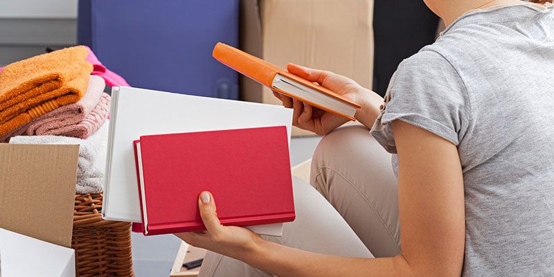 A Person Sorting Books.