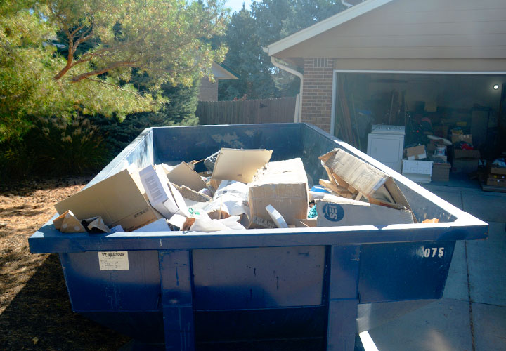 a roll off dumpster full of debris from a home cleanout