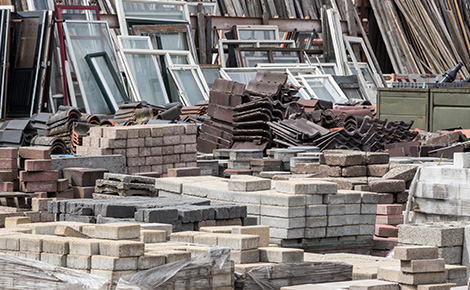 Bricks along with other construction materials stacked and organized.