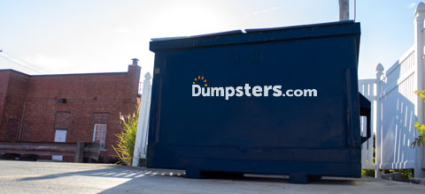 front load dumpster in business parking lot