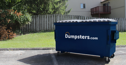 commercial dumpster on wheels placed on a parking lot